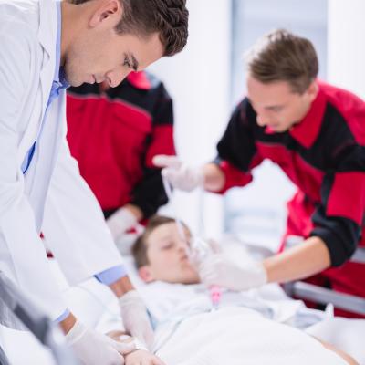 Doctors Adjusting Oxygen Mask While Rushing Patient Emergency Room